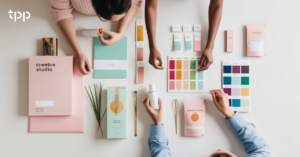 A group of people review branding materials to promote catering software